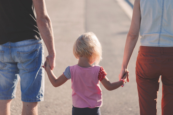 familia tomados de la mano padres niño