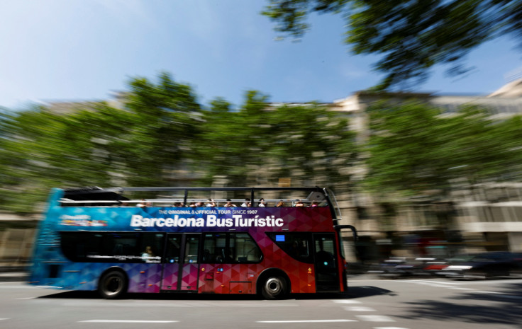 En tourist bus passes by Paseo de Gracia in Barcelona