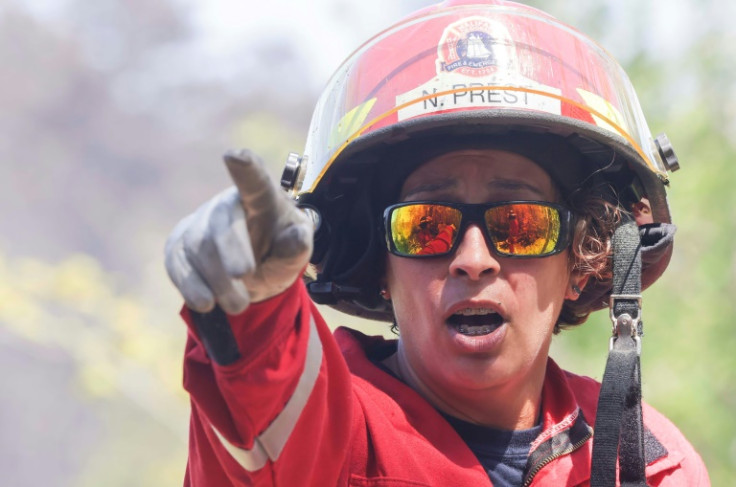 En esta imagen del 30 de mayo, cortesía del gobierno de Nueva Escocia en Canadá, la capitana Natasha Prest de la Estación Regional de Bomberos y Emergencias 54 de Halifax dirige a los bomberos que trabajan para apagar incendios forestales en el área de Ta